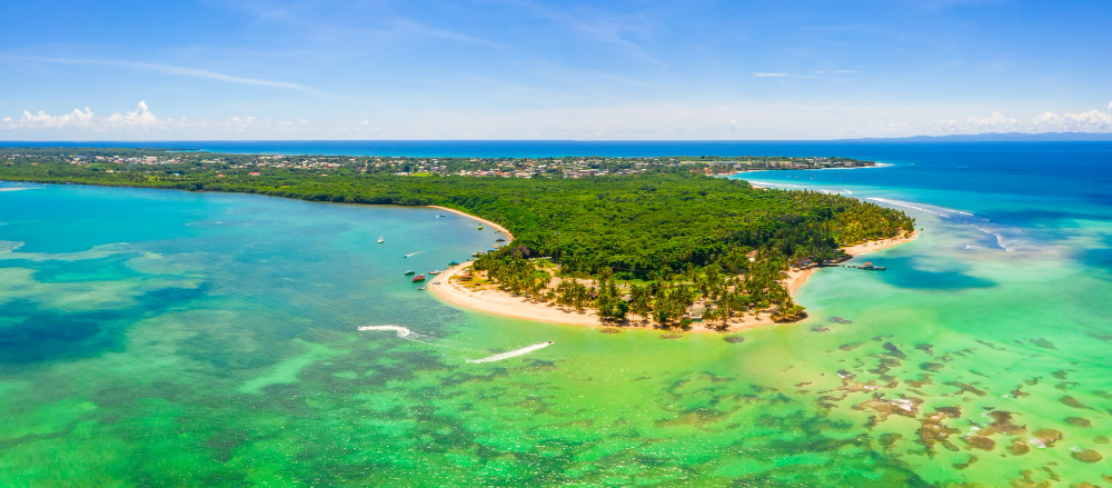 aerial-panoramic-view-tropical-island-beautifully-coned-with-lush-trees-clear-sky